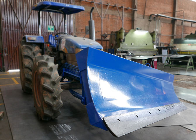 cuchilla agricola sobre tractor new holland